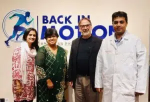 Dr. Tazia Sardar, Dr. Md. Abdullah Yousuf, and global medical consultants standing together at Back in Motion, the premier physiotherapy center near me in Dhaka.